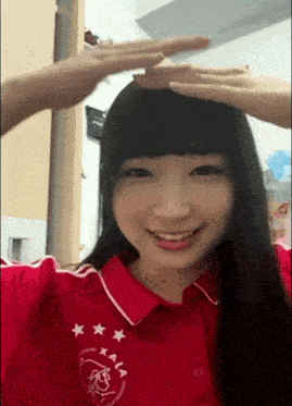 a woman wearing a red shirt with a heart and stars on it