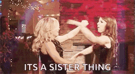 two women are dancing together in a room with the words `` it 's a sister thing '' written on the bottom .