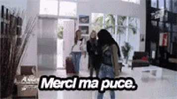 a group of people are standing in a room with the words merci ma puce written on the bottom