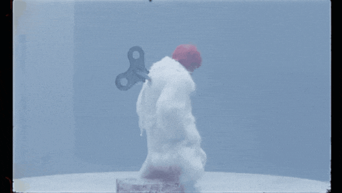 a snowman with a wind up key on his back