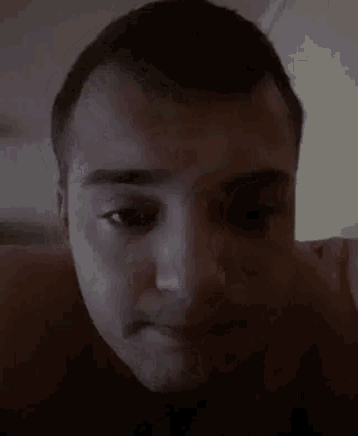 a close up of a man 's face with a serious look on his face