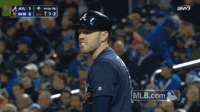 a baseball player stands in front of a crowd with mlb.com in the corner