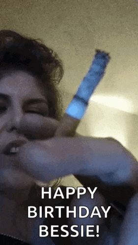 a woman is smoking a cigarette and says happy birthday bessie !