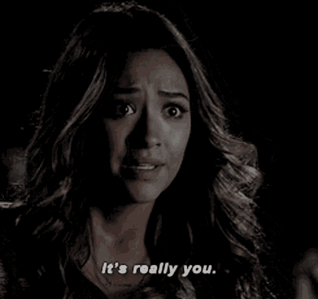 a woman is saying it 's really you in a dark room