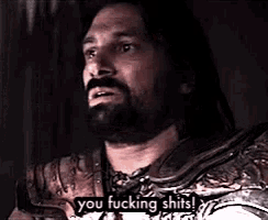 a man with a beard is talking and saying `` you fucking shits ! ''