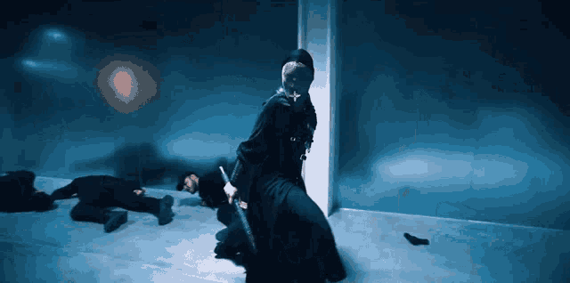 a man in a mask is kneeling down with a gun in his hand