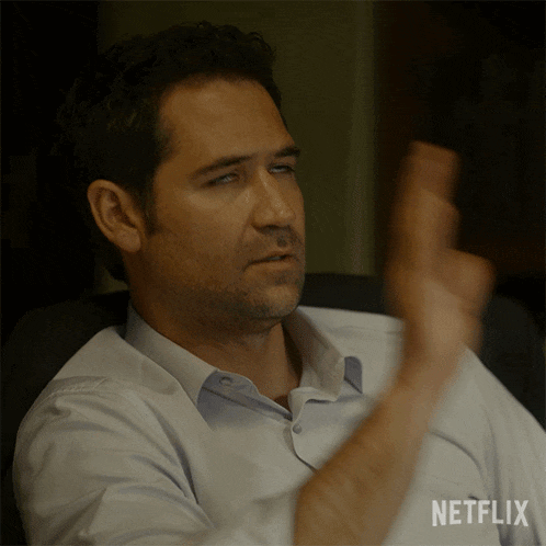 a man sitting in a chair with a netflix logo on his shirt