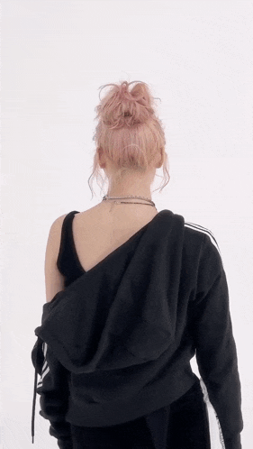 the back of a woman wearing a black hoodie