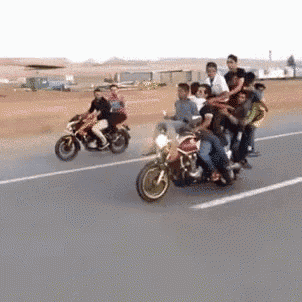 a group of people are riding motorcycles on a road .