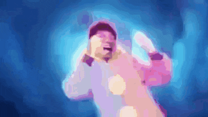 a blurry picture of a man in a pink and purple jacket