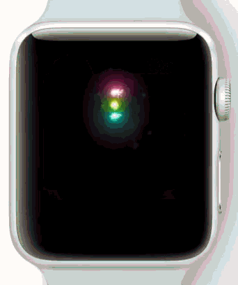a close up of an apple watch with a rainbow colored light on it