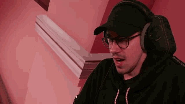 a man wearing headphones and a hat with the word headphones on the front
