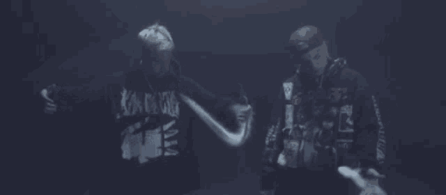 two men standing next to each other with smoke coming out of their mouths .