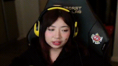 a woman wearing headphones is making a funny face while looking at the camera .