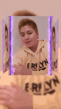 a person wearing a hoodie that says erinlyn