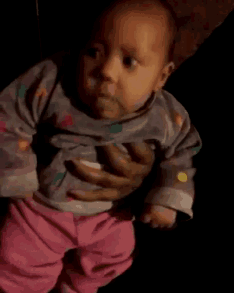 a person is holding a baby in their arms who is wearing pink pants