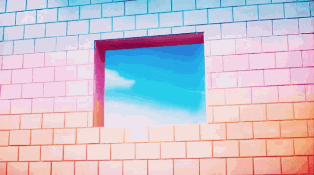 a brick wall with a window that looks out to the sky