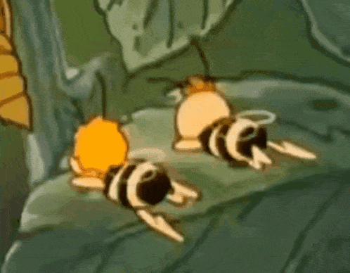a couple of bees are laying on a leaf .