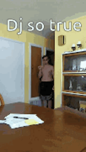a man standing in a room with the words dj so true written on it