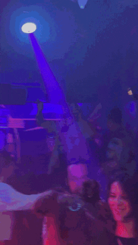 a man in a lemon shirt is dancing in a crowd