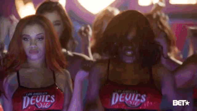 a group of women wearing los angeles devils outfits