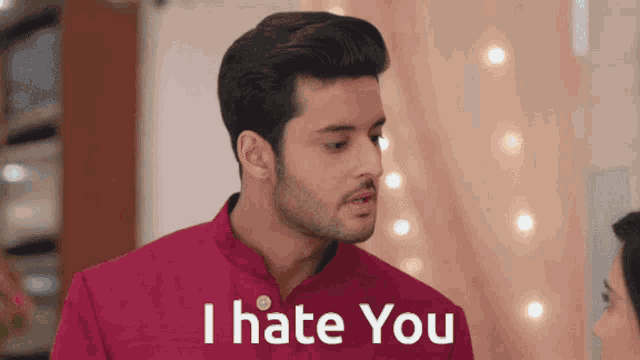 a man in a red shirt has the words i hate you on his chest