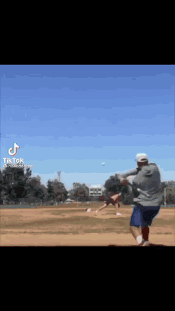 a man is swinging a bat at a baseball on a field