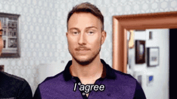 a man with a beard and mustache is wearing a purple shirt and saying i agree .