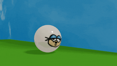 a white ball with a cartoon face on it is on a grassy hill