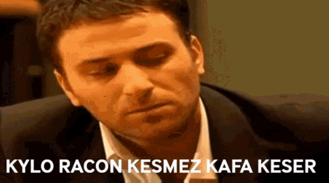 a man in a suit and white shirt with kylo racon kesmez kafa keser written above him