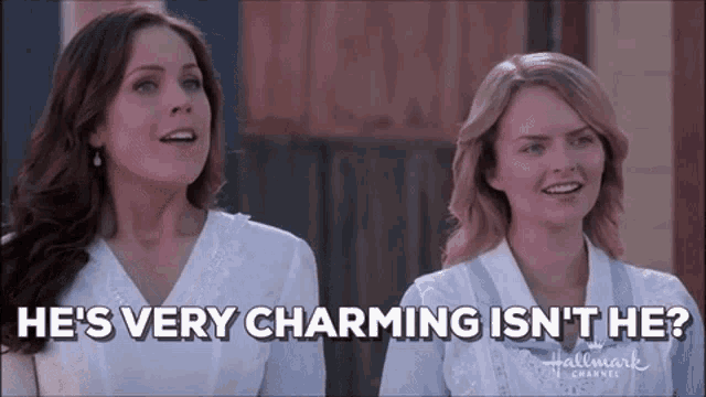 two women are standing next to each other and one of them says he 's very charming isn 't he ?