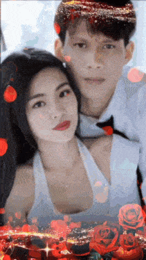 a man and woman are posing for a picture with red roses in the background