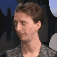 a close up of a man 's face with his eyes closed and a blurred background .