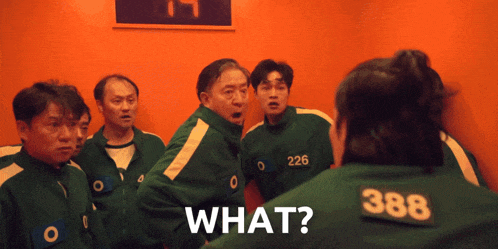 a group of men are standing in a room and one has the number 388 on his jacket