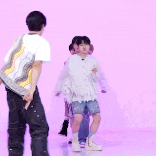 a group of people are dancing together on a stage .