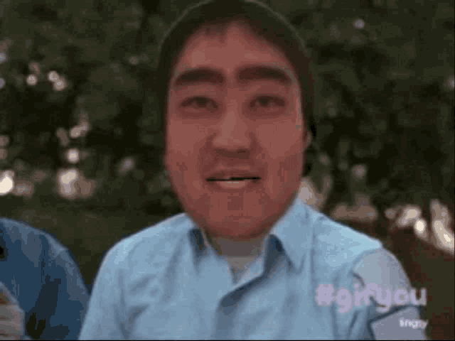 a man wearing a blue shirt with #gifyou written on the sleeve