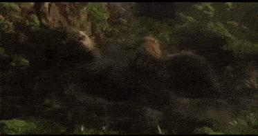 a blurred image of a giant gorilla standing in the middle of a forest .
