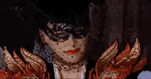 a woman wearing a mask and gloves is standing in a room .