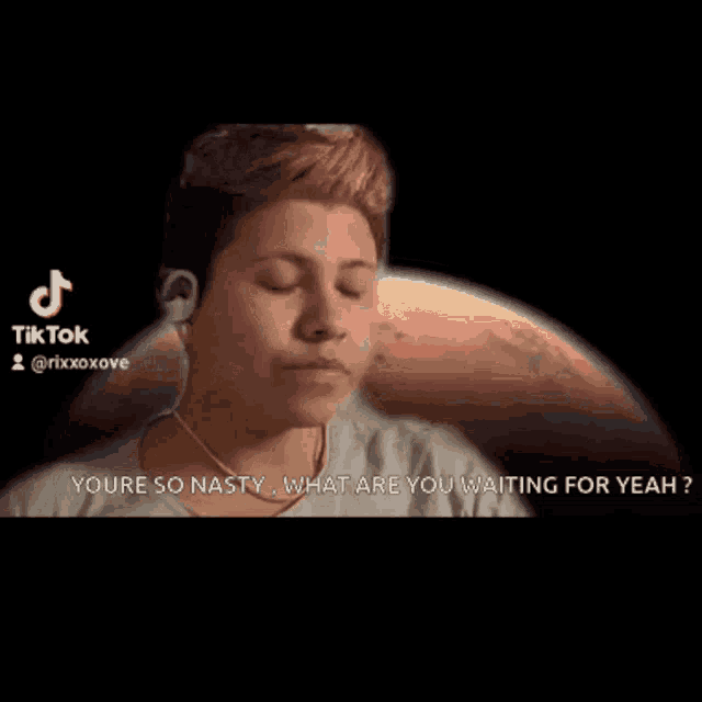 a woman wearing headphones says " you 're so nasty what are you waiting for yeah " in front of a planet