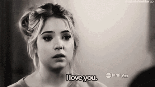 a black and white photo of a woman saying i love you .