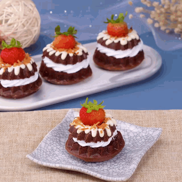 a small cake with a strawberry on top on a plate