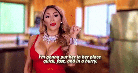 a woman in a red dress is talking about putting her in her place quick , fast and in a hurry