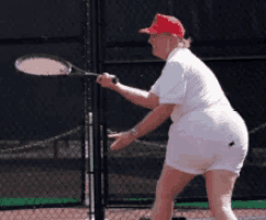 a woman in a red hat is playing tennis