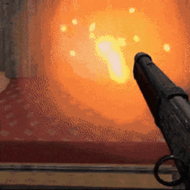 a gun with a ring on it is pointing at a fireball