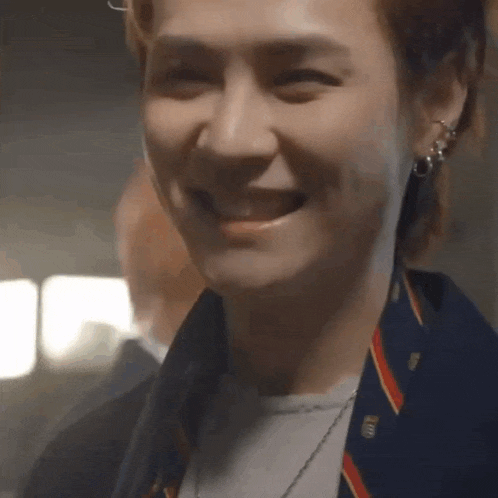 a close up of a man 's face with a smile on it .