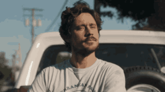 a man with a beard is wearing a shirt that says arkansas on it