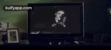 a black and white photo of a man is displayed on a television screen