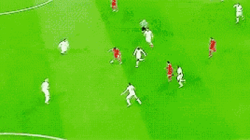 a soccer game is being played on a green field