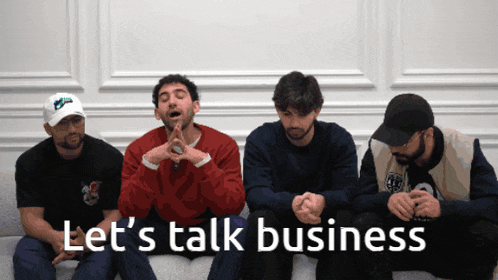a group of men sit on a couch with the words let 's talk business