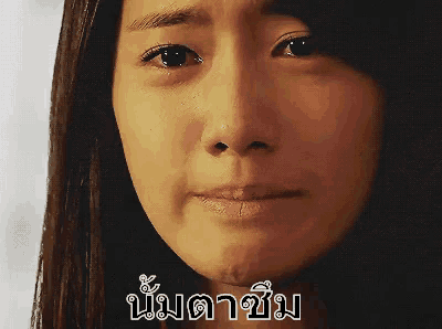a close up of a woman 's face with a foreign language written on it